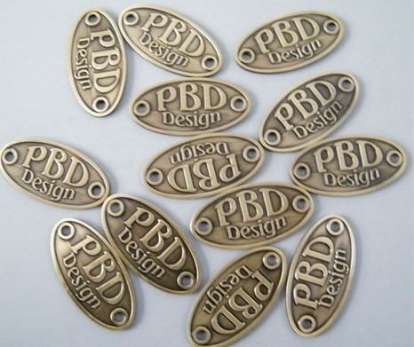 brass oval badge